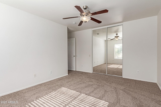 unfurnished bedroom with carpet flooring, ceiling fan, and a closet