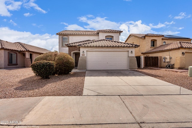 mediterranean / spanish-style home with a garage