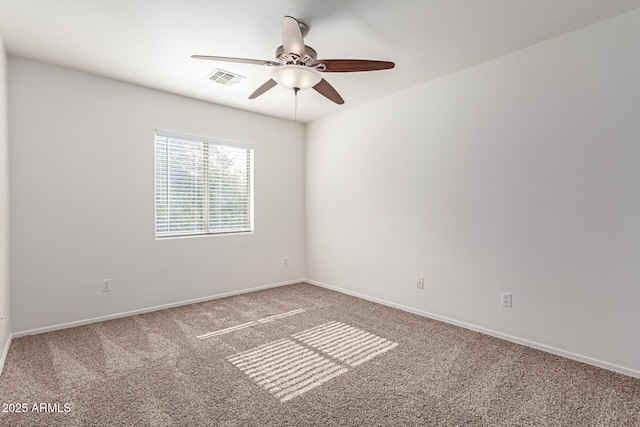 empty room with ceiling fan and carpet floors