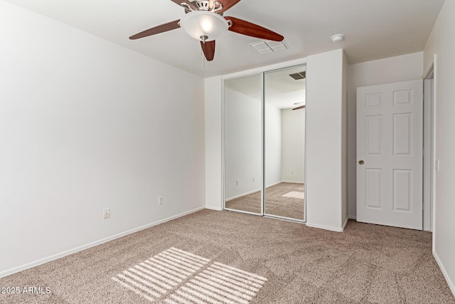 unfurnished bedroom with light carpet, a closet, and ceiling fan