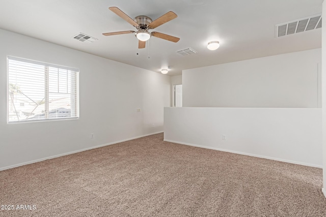 carpeted spare room featuring ceiling fan