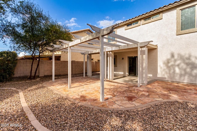 back of property with a pergola and a patio area