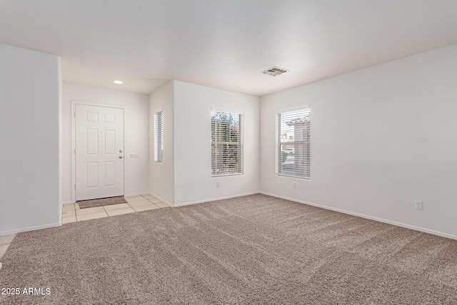 unfurnished room featuring light colored carpet