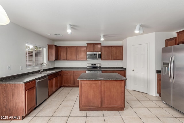 kitchen with a center island, appliances with stainless steel finishes, sink, and light tile patterned flooring