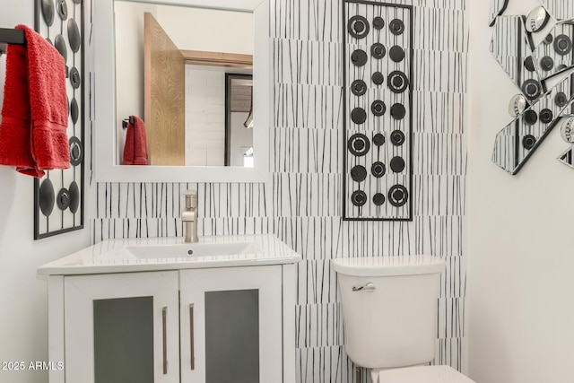 bathroom featuring toilet and vanity
