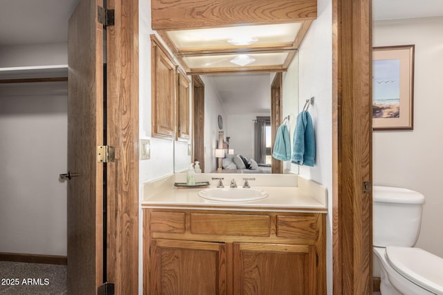 ensuite bathroom featuring toilet, vanity, and ensuite bath