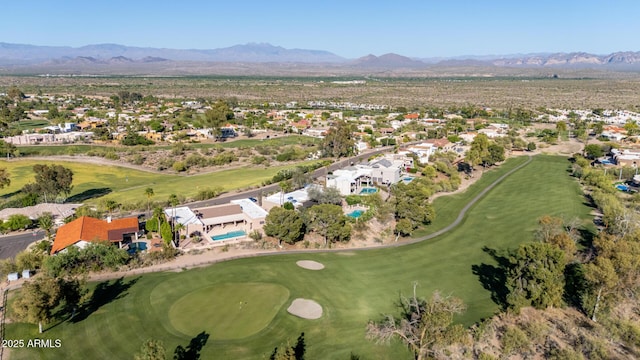 drone / aerial view with a residential view, a mountain view, and view of golf course