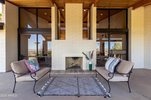 view of patio featuring an outdoor brick fireplace