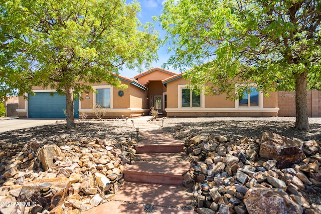 3501 Camino Bella Rosa, Sierra Vista, AZ 85650 - view of front facade with fence, an attached garage, a tile roof, stucco siding, and concrete driveway