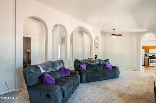 3501 Camino Bella Rosa, Sierra Vista, AZ 85650 - living room with a ceiling fan, baseboards, light colored carpet, and arched walkways