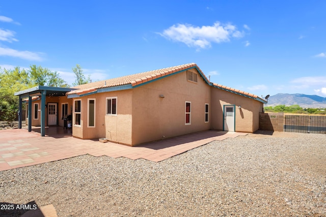 3501 Camino Bella Rosa, Sierra Vista, AZ 85650 - rear view of property with fence, a mountain view, stucco siding, and a tile roof