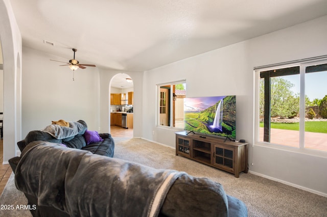 3501 Camino Bella Rosa, Sierra Vista, AZ 85650 - living room with arched walkways, ceiling fan, visible vents, and light colored carpet