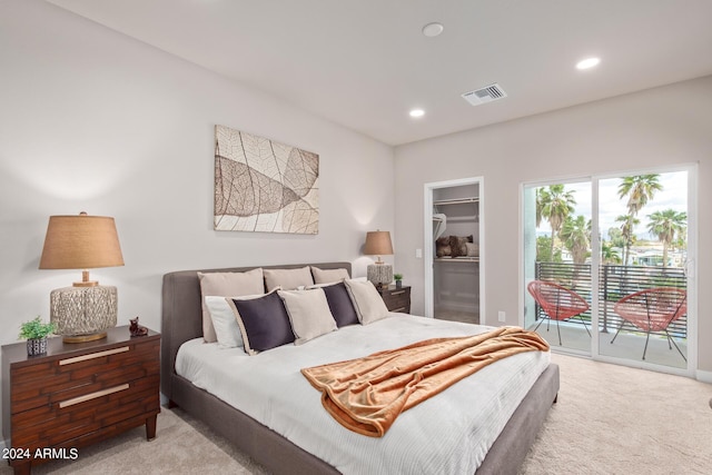 carpeted bedroom featuring access to outside, a spacious closet, and a closet