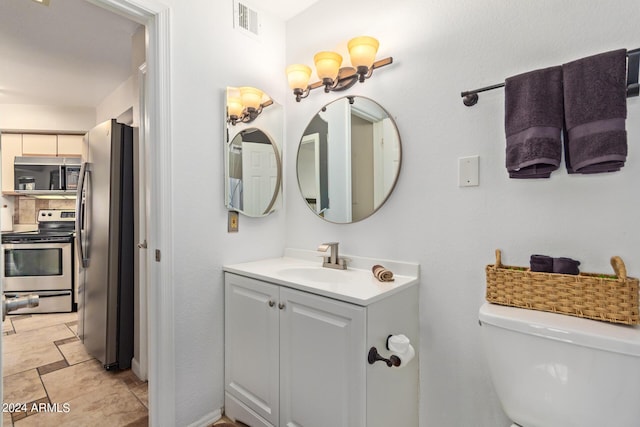 bathroom with vanity and toilet