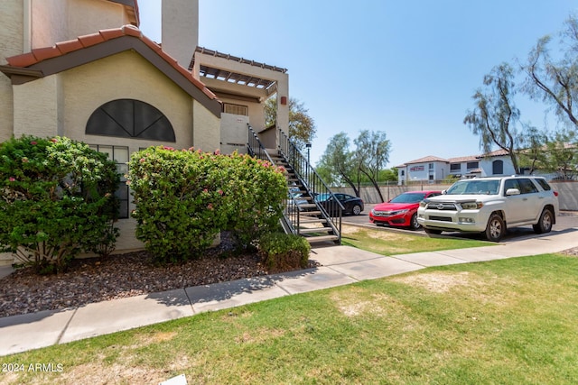 view of side of home featuring a lawn