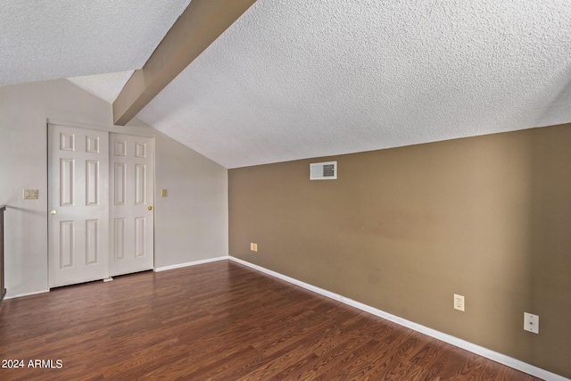 bonus room featuring lofted ceiling with beams, dark hardwood / wood-style flooring, and a textured ceiling