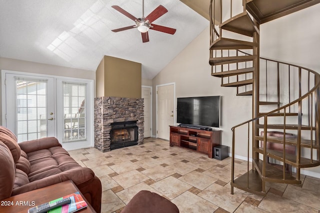 living room with ceiling fan, a fireplace, and high vaulted ceiling