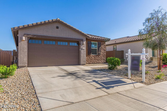 19415 W College Dr, Litchfield Park, AZ 85340 - mediterranean / spanish house featuring stucco siding, a garage, driveway, a tiled roof, and stone siding