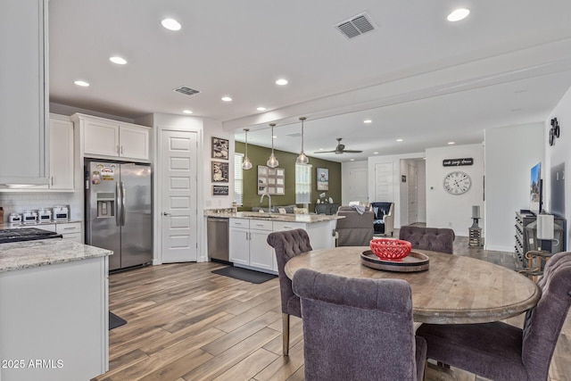 19415 W College Dr, Litchfield Park, AZ 85340 - dining room with recessed lighting, light wood-style floors, and ceiling fan
