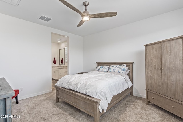19415 W College Dr, Litchfield Park, AZ 85340 - bedroom with light colored carpet, baseboards, ensuite bathroom, a ceiling fan, and a sink