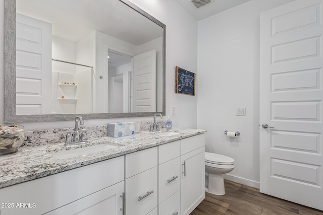 19415 W College Dr, Litchfield Park, AZ 85340 - bathroom with wood finished floors, double vanity, baseboards, and toilet