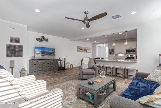 19415 W College Dr, Litchfield Park, AZ 85340 - living area featuring light wood-style flooring, ceiling fan, and recessed lighting