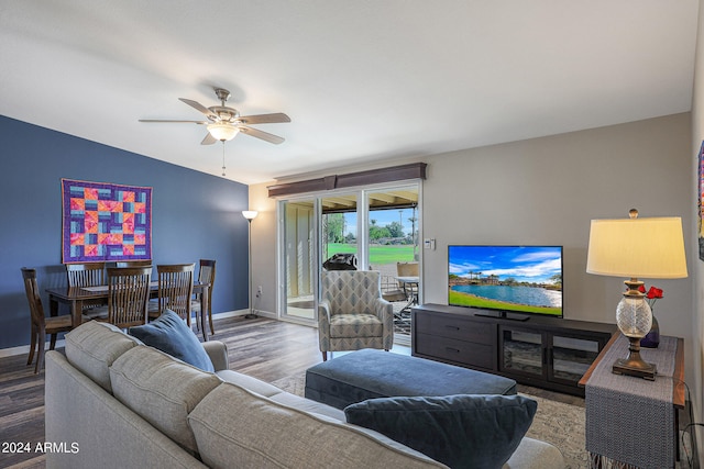 living room with vaulted ceiling, hardwood / wood-style floors, and ceiling fan