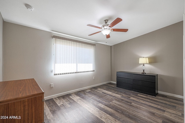 unfurnished bedroom featuring ceiling fan and dark wood-type flooring