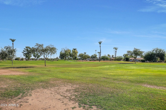 view of community with a yard and golf course view