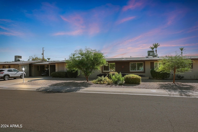 single story home featuring driveway and central AC