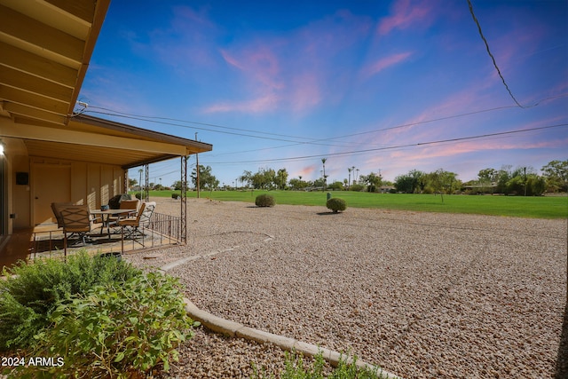 yard at dusk with a patio area