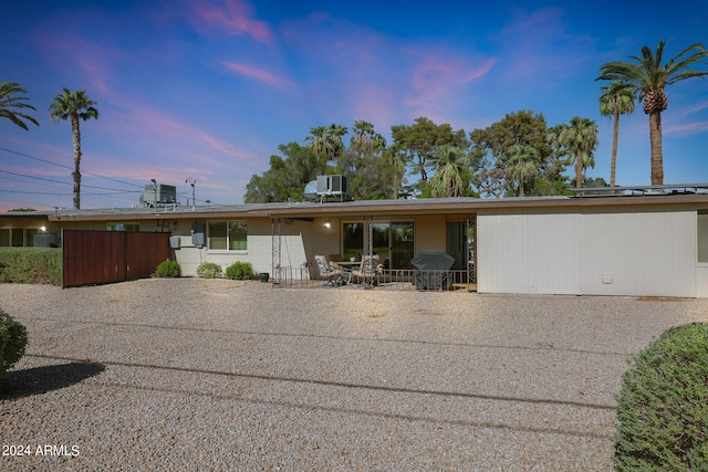 view of front of property with cooling unit and a patio area