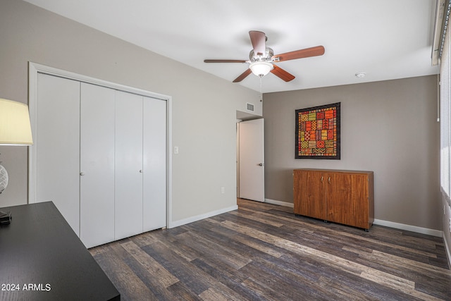 unfurnished bedroom featuring ceiling fan, a closet, dark hardwood / wood-style flooring, and lofted ceiling