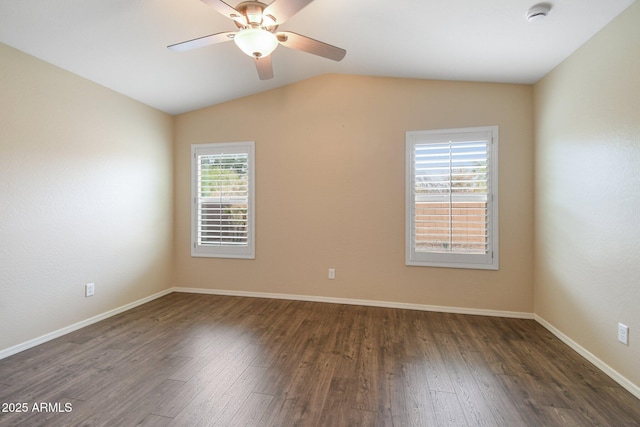 unfurnished room with vaulted ceiling, wood finished floors, and baseboards