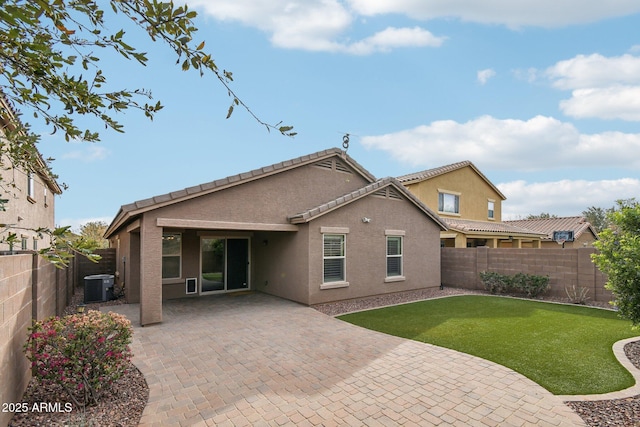 rear view of house with cooling unit, a fenced backyard, a patio, and stucco siding