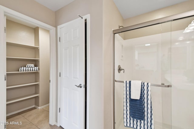 full bathroom featuring a shower stall and tile patterned floors