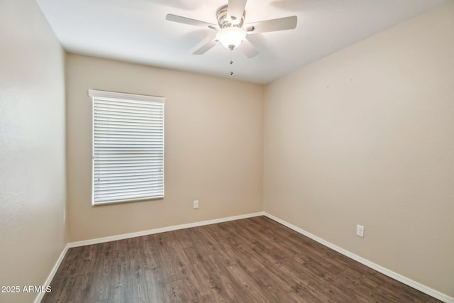 spare room with ceiling fan, baseboards, and wood finished floors