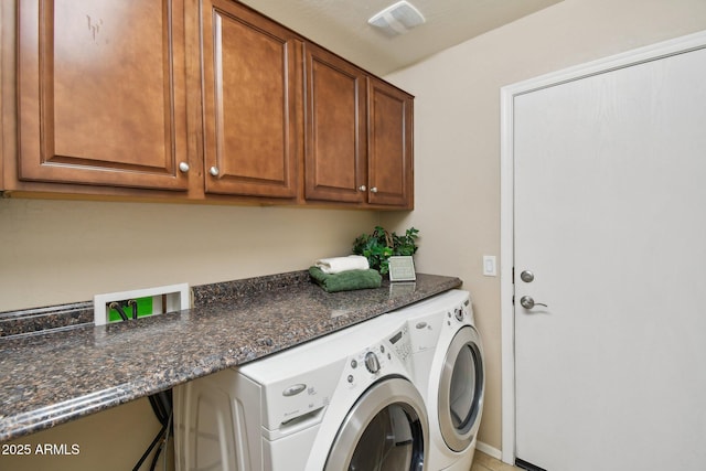 laundry area featuring cabinet space, visible vents, and washing machine and clothes dryer