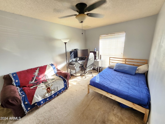 bedroom featuring carpet flooring, a textured ceiling, and ceiling fan