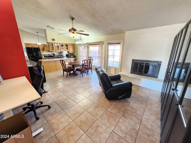 tiled living room featuring a brick fireplace, a textured ceiling, lofted ceiling, and ceiling fan