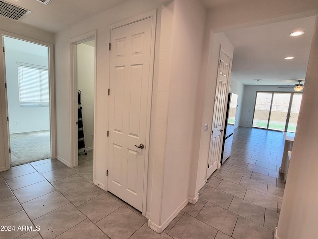 corridor featuring light tile patterned floors