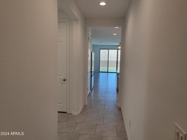 hall with light tile patterned floors