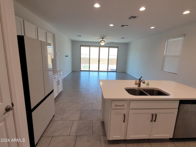 kitchen with white cabinets, dishwasher, white refrigerator, and sink