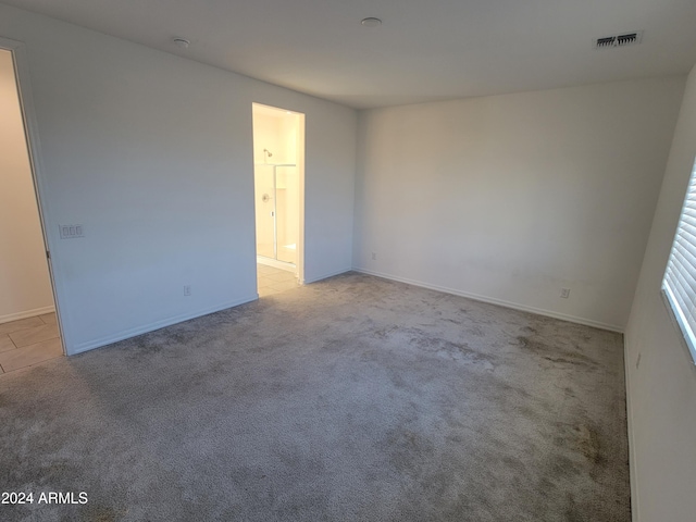 unfurnished room with light carpet