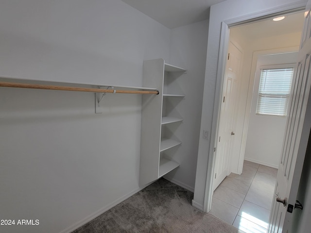 spacious closet featuring light tile patterned floors