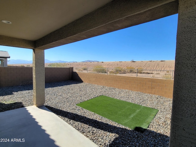 view of yard with a mountain view and a patio