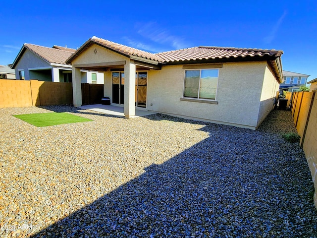 back of house with a patio