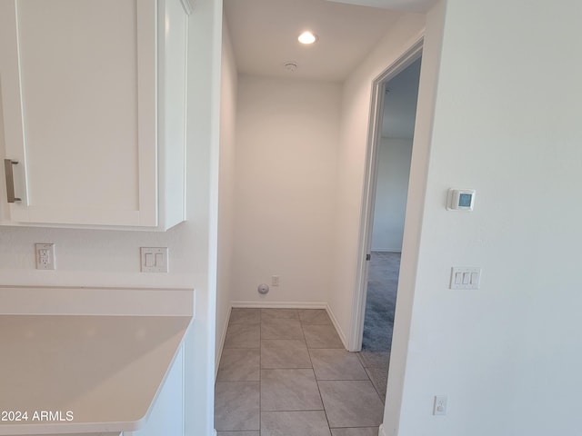 corridor featuring light tile patterned floors