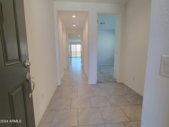 hall featuring light tile patterned floors