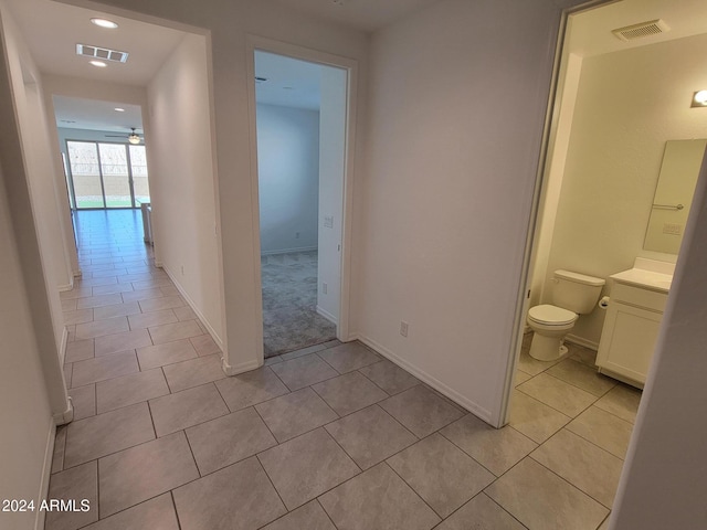 hallway featuring light tile patterned floors